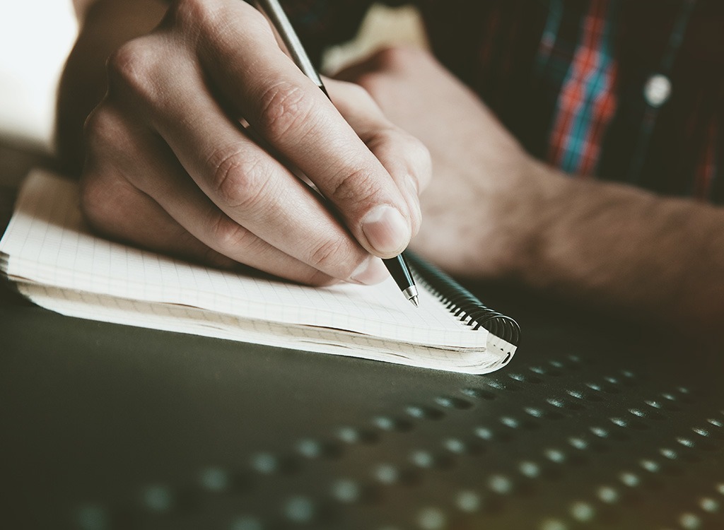 man-writing-in-journal